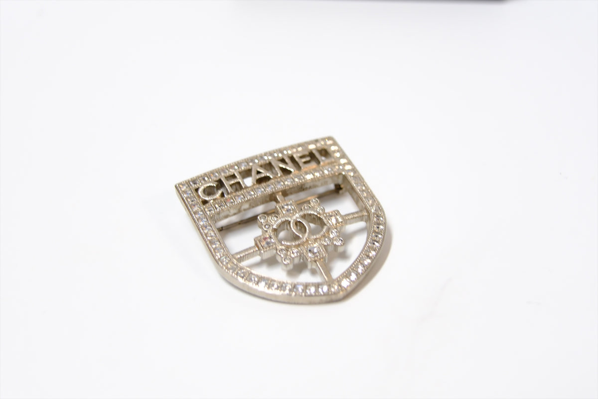 CHANEL SHIELD BROOCH WITH CRYSTALS SHW